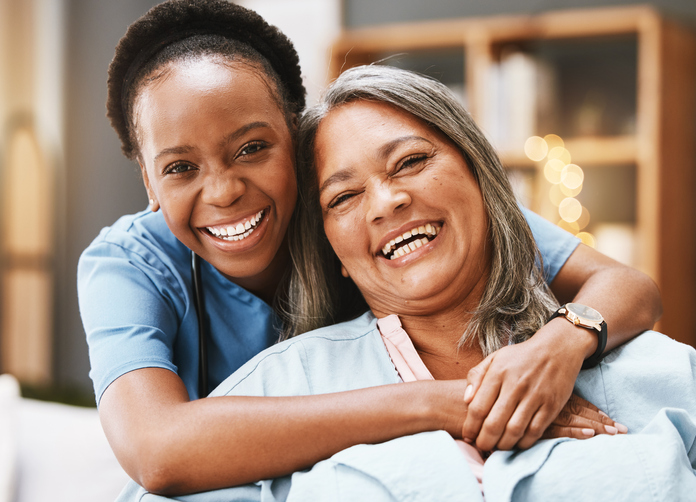 Nurse and patient embracing and smiling